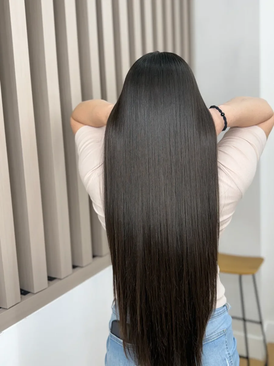 Long, sleek dark hair with a glossy smoothing finish